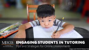 An elementary-aged boy rests his chin on top of a white worksheet while sitting at a table. He holds a pencil in his hand like he is writing, and his cheeks are expanded and mouth pursed as if he is holding his breath. This image is a thumbnail link to a training enttitled Engaging Students in Tutoring: Tips and Strategies for Online Environments